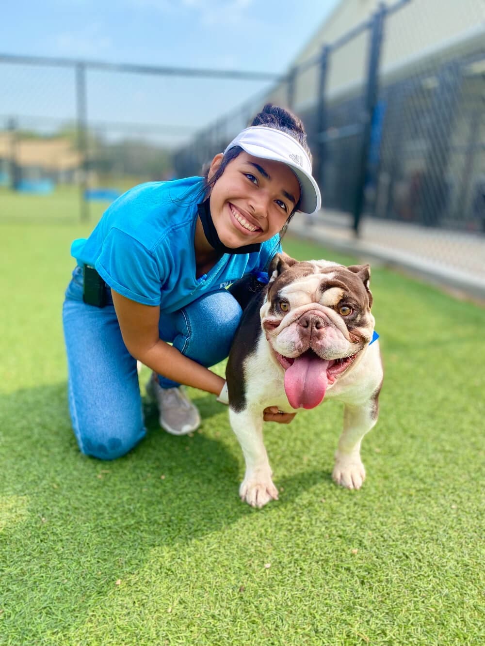 meadowlake pet resort employee posing with bulldog